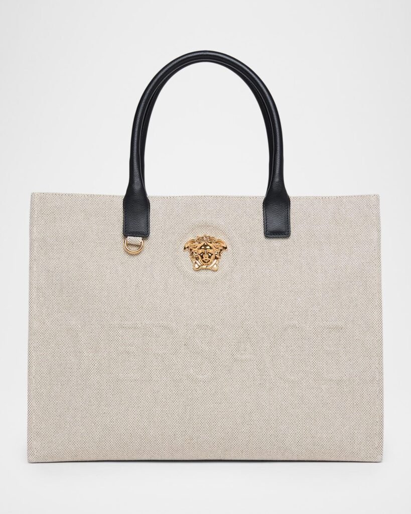 Beige Versace La Medusa canvas tote with black leather handles.