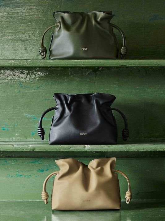 Loewe Flamenco clutch bags in olive, black, and beige.